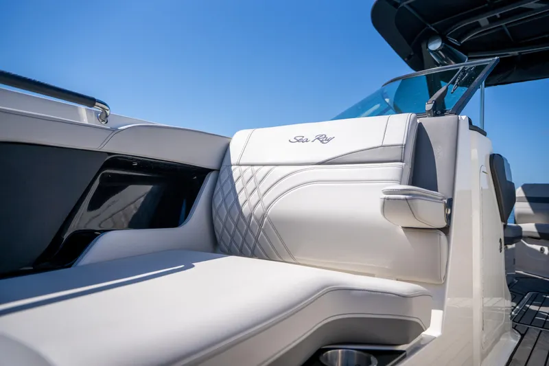 Slide: The Image of 2023 Sea Ray SLX 260 Outboard luxury seating detail under clear blue sky. - 43