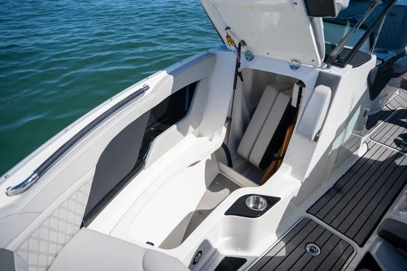 Slide: The Image of 2023 Sea Ray SLX 260 Outboard boat interior with open storage compartment. - 44