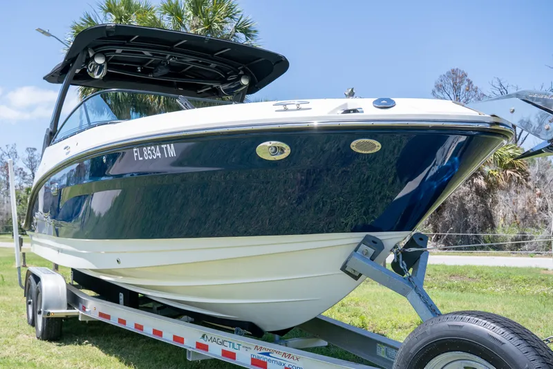Slide: The Image of 2023 Sea Ray SLX 260 Outboard boat on trailer, parked on grass. - 8