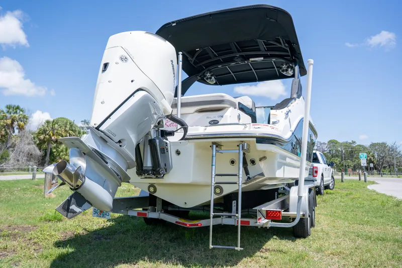 Slide: The Image of 2023 Sea Ray SLX 260 Outboard boat on trailer, rear view, sunny day. - 9