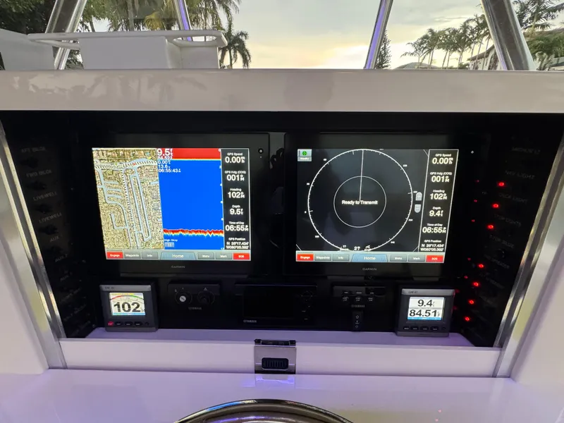 Slide: The Image of Dashboard of a 2013 Bahama 41 boat with navigation and radar displays. - 13