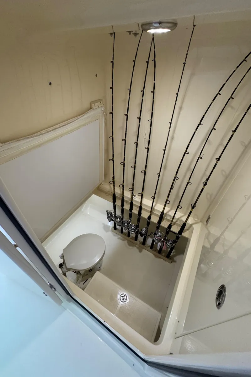 Slide: The Image of Interior of 2013 Bahama 41 boat with fishing rod storage and compact toilet. - 15