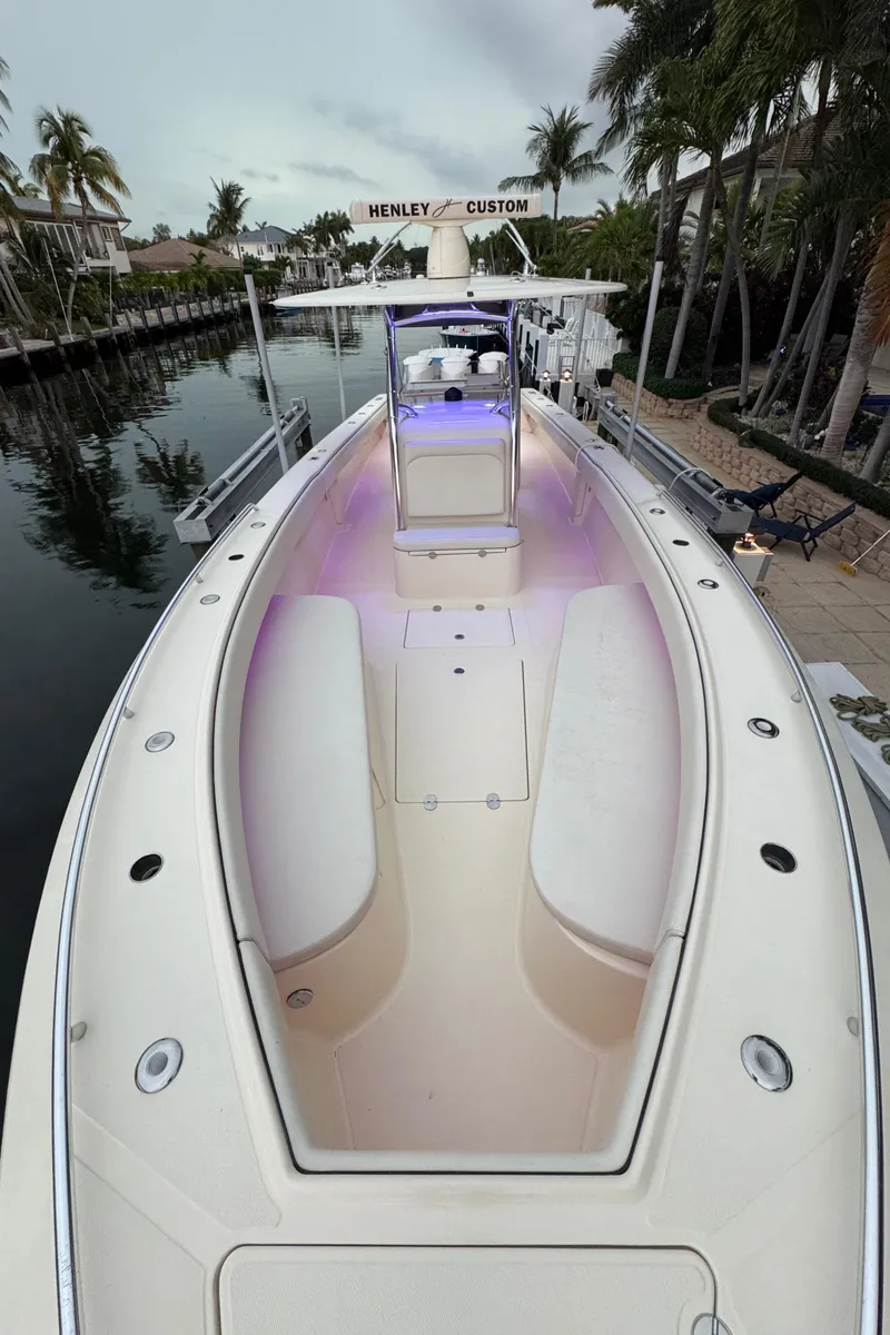 Slide: The Image of 2013 Bahama 41 boat docked, showcasing spacious deck and sleek design. - 23