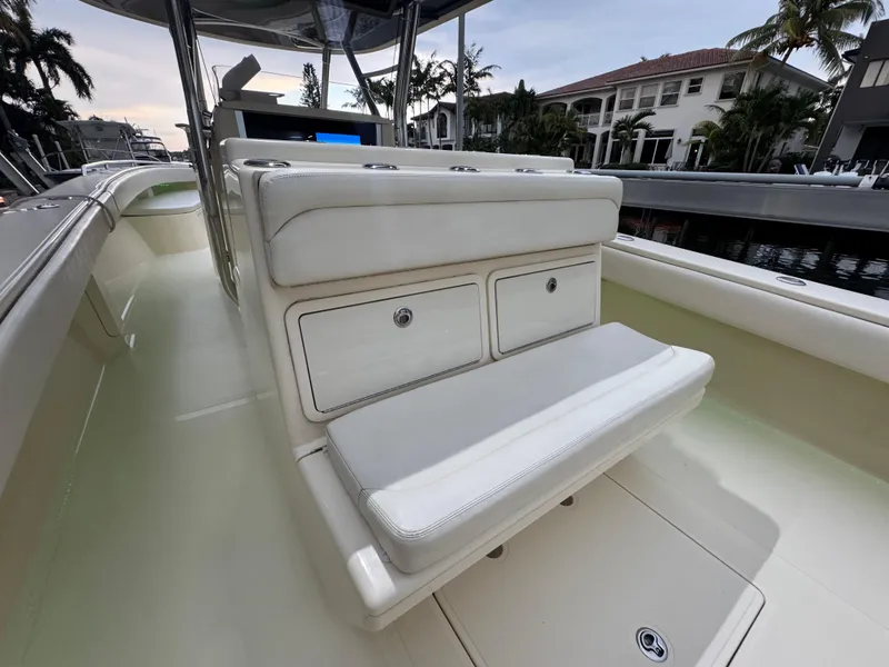 Slide: The Image of 2013 Bahama 41 boat interior with white seating and storage compartments. - 7