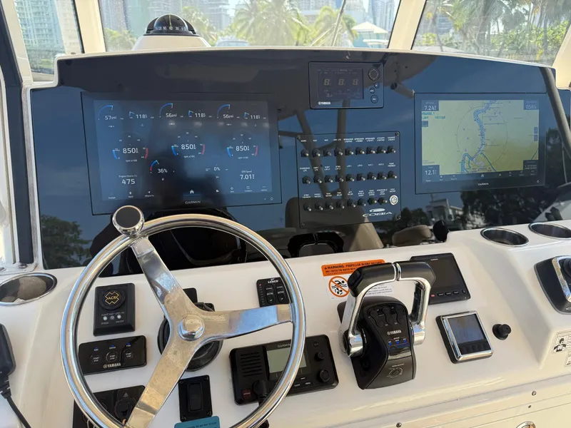 Slide: The Image of 2018 Cobia 344 Center Console boat dashboard with navigation and control systems. - 4
