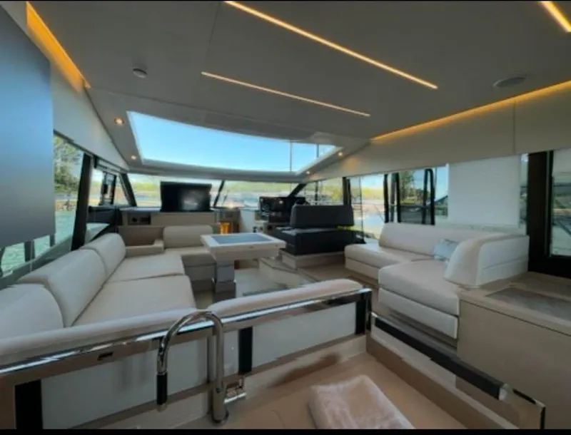 Slide: The Image of Luxurious interior of 2023 Prestige 520S yacht with modern seating and panoramic windows. - 6