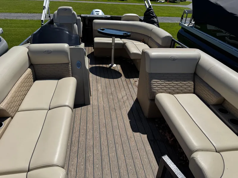 Slide: The Image of 2022 Montego Bay 8522 2PT BK DLX Fish & Cruise boat interior with beige seating and table. - 13