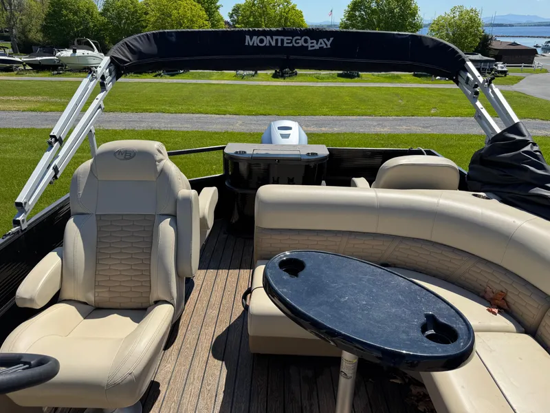 Slide: The Image of 2022 Montego Bay 8522 2PT BK DLX Fish & Cruise boat interior with seating and table. - 14