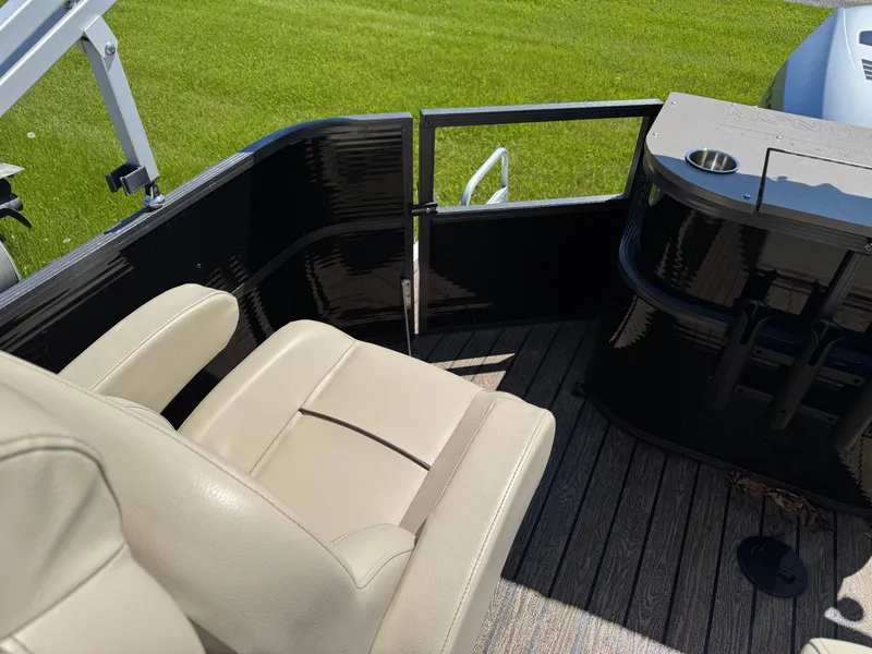 Slide: The Image of 2022 Montego Bay 8522 2PT BK DLX Fish & Cruise boat interior with beige seating and black paneling. - 17