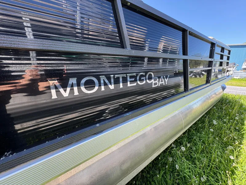 Slide: The Image of 2022 Montego Bay 8522 2PT BK DLX Fish & Cruise pontoon boat on grass. - 2