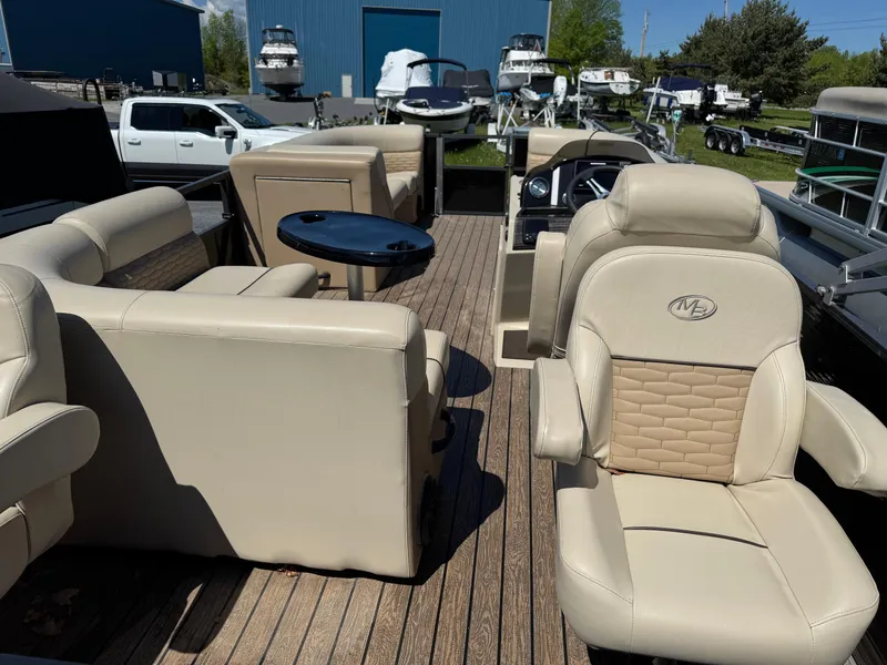 Slide: The Image of 2022 Montego Bay 8522 2PT BK DLX Fish & Cruise boat interior with beige seating and wood flooring. - 6