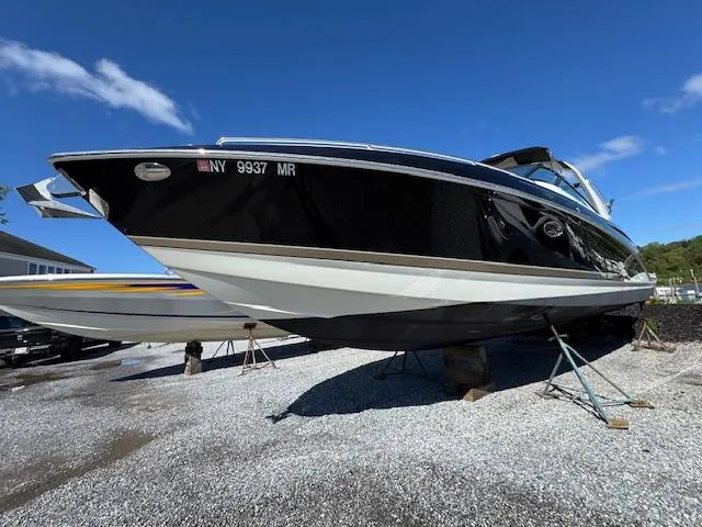 The Image of 2015 Formula 350 Crossover Bowrider boat on stands, clear sky background. - 0