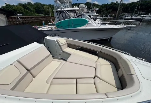 Slide: The Image of 2015 Formula 350 Crossover Bowrider with spacious seating in a marina setting. - 17