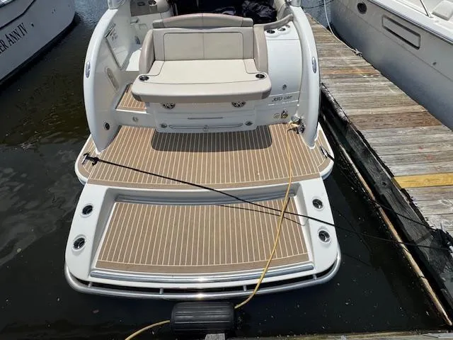 Slide: The Image of 2015 Formula 350 Crossover Bowrider docked, featuring spacious rear deck and seating. - 18