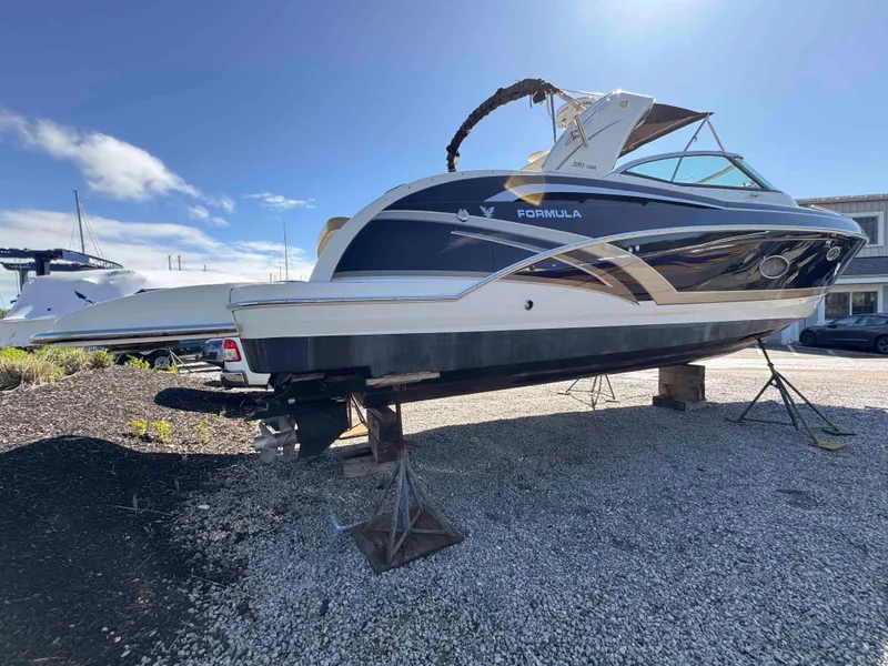 Slide: The Image of 2015 Formula 350 Crossover Bowrider on gravel, side view, sunny day. - 2