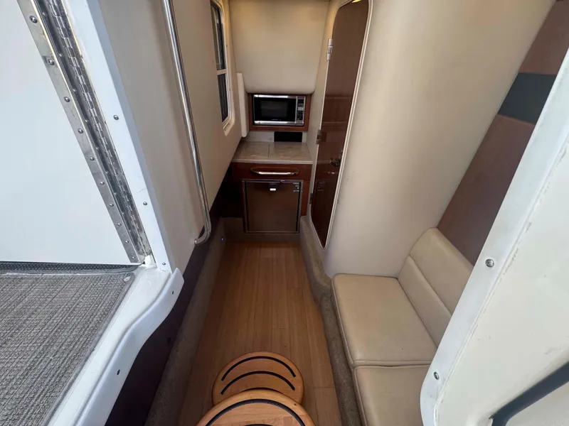 Slide: The Image of 2015 Formula 350 Crossover Bowrider interior with kitchenette and seating area. - 21