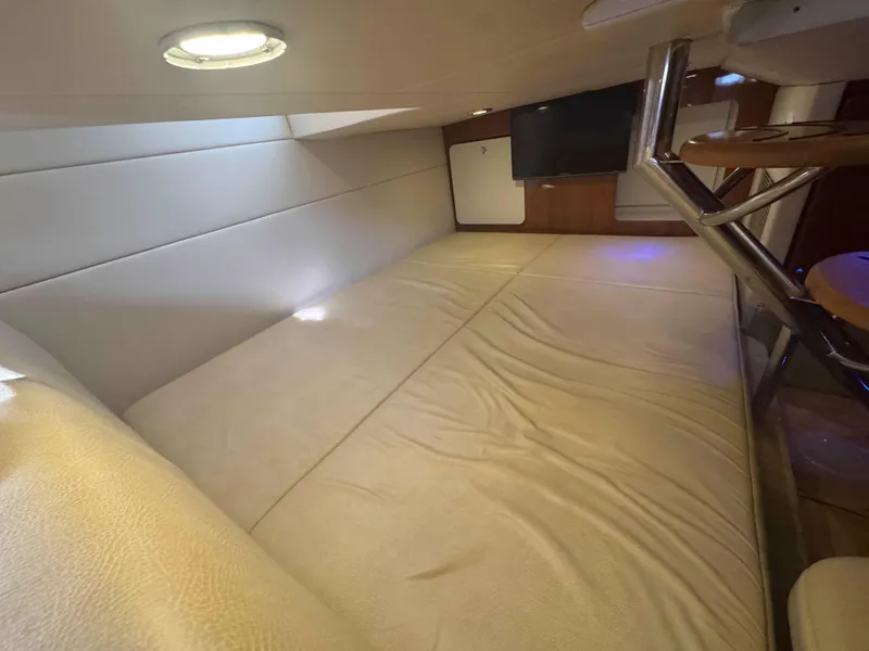 Slide: The Image of 2015 Formula 350 Crossover Bowrider cabin interior with bed and TV. - 23