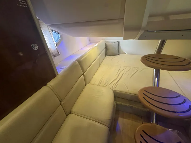 Slide: The Image of 2015 Formula 350 Crossover Bowrider interior with beige seating and wooden steps. - 24