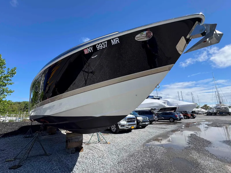 Slide: The Image of 2015 Formula 350 Crossover Bowrider on stands, parked outdoors under blue sky. - 4
