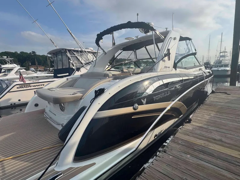 Slide: The Image of 2015 Formula 350 Crossover Bowrider docked at marina, sleek design, sunny day. - 6
