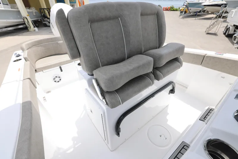 Slide: The Image of 2025 Sea Hunt Ultra 245 SE boat interior with cushioned seating and console. - 12