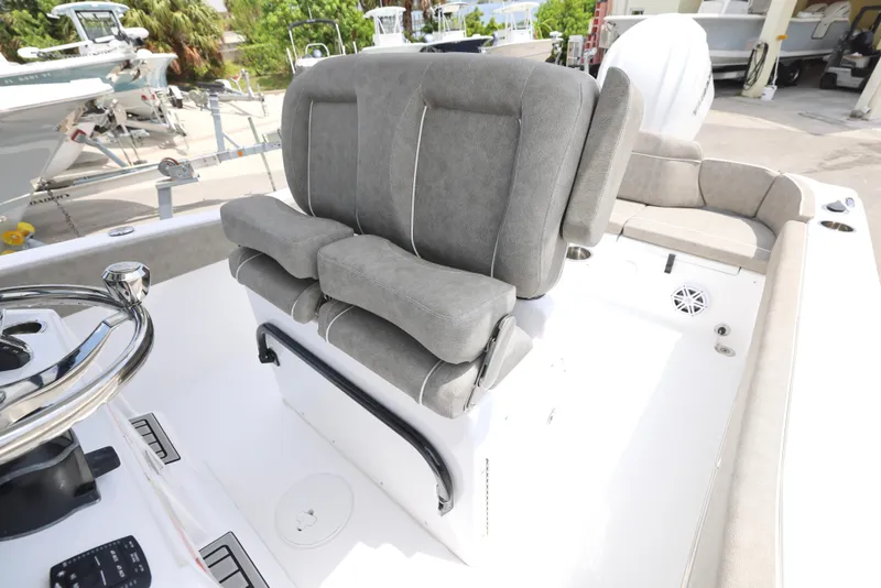 Slide: The Image of 2025 Sea Hunt Ultra 245 SE boat with plush gray seating and steering wheel. - 13