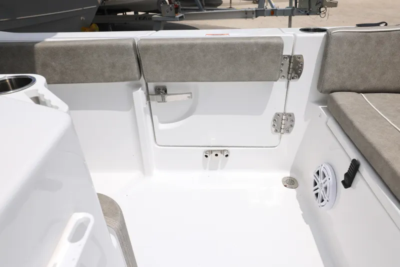 Slide: The Image of 2025 Sea Hunt Ultra 245 SE boat interior with cushioned seating and storage compartment. - 14