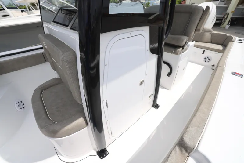 Slide: The Image of 2025 Sea Hunt Ultra 245 SE boat interior with cushioned seating and storage compartments. - 15