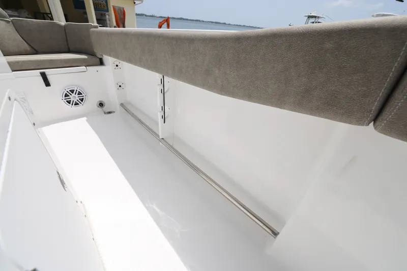 Slide: The Image of Interior view of 2025 Sea Hunt Ultra 245 SE boat, featuring seating and speaker. - 17