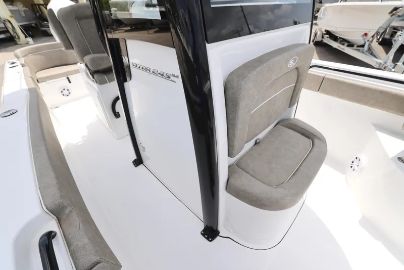 Slide: The Image of 2025 Sea Hunt Ultra 245 SE boat interior with cushioned seating and sleek design. - 18