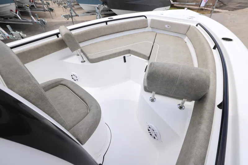 Slide: The Image of 2025 Sea Hunt Ultra 245 SE boat interior with cushioned seating and speakers. - 19