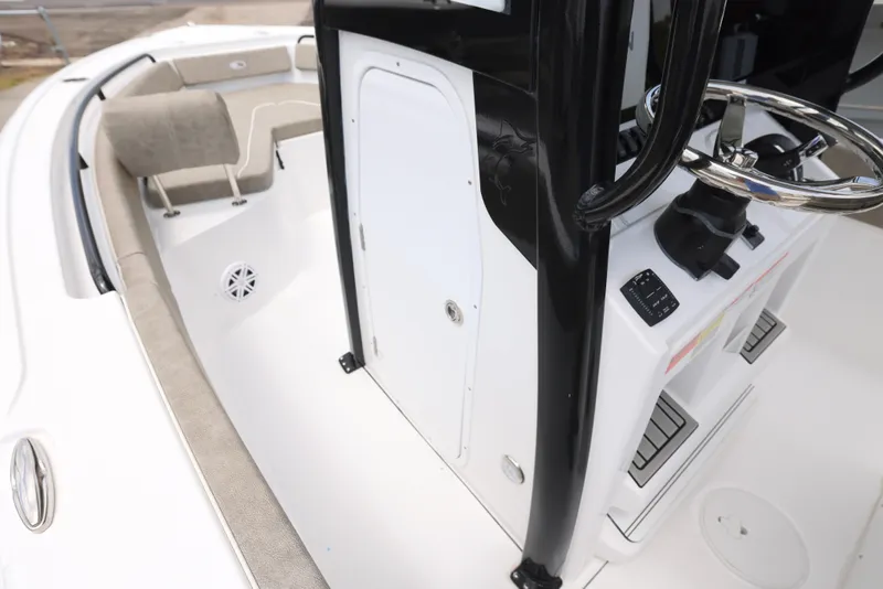Slide: The Image of 2025 Sea Hunt Ultra 245 SE boat interior with steering console and seating area. - 23