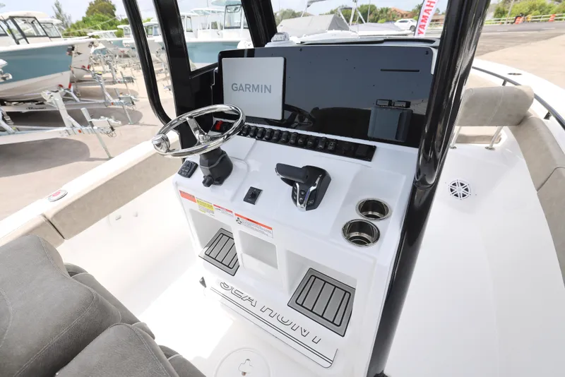 Slide: The Image of 2025 Sea Hunt Ultra 245 SE boat console with Garmin display and steering wheel. - 3