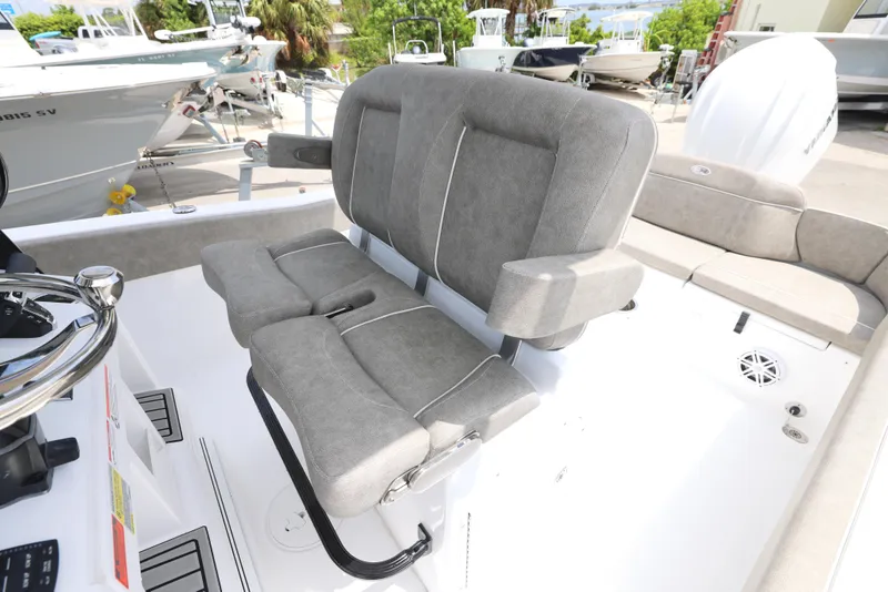 Slide: The Image of 2025 Sea Hunt Ultra 245 SE boat seating with gray upholstery and armrests. - 6