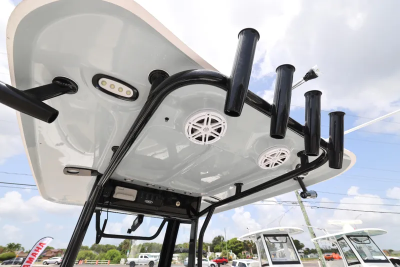 Slide: The Image of 2025 Sea Hunt Ultra 245 SE boat T-top with rod holders and speakers. - 7