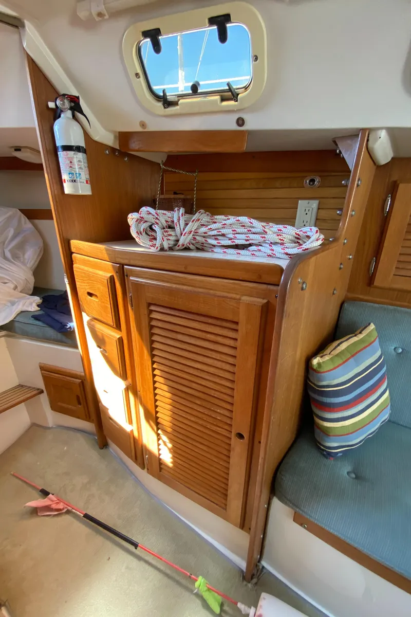 Slide: The Image of Interior of 1992 Catalina 30 MkII sailboat with wooden cabinetry and nautical decor. - 11