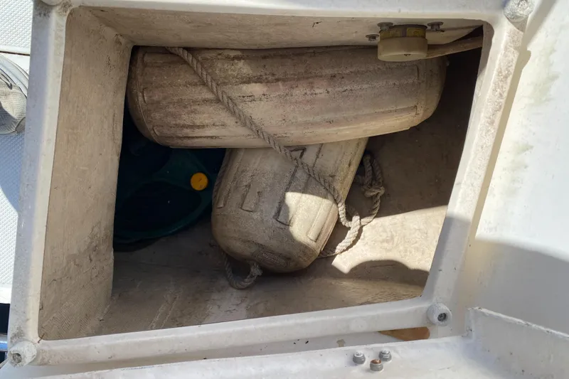 Slide: The Image of Storage compartment on a 1992 Catalina 30 MkII sailboat with fenders and equipment. - 13