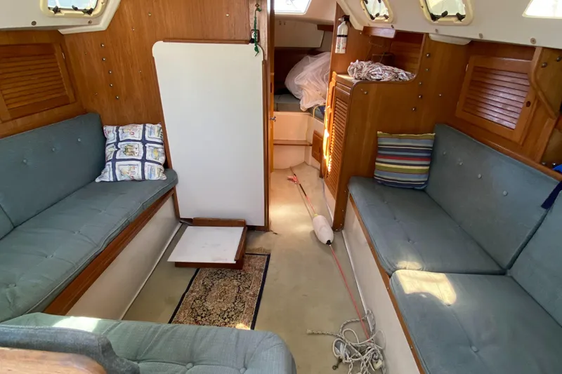 Slide: The Image of Interior of a 1992 Catalina 30 MkII sailboat with cozy seating and wooden accents. - 16
