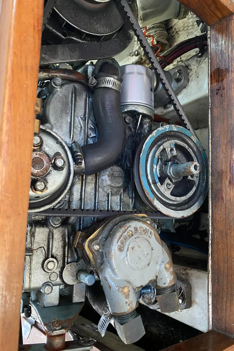 Slide: The Image of Engine compartment of a 1992 Catalina 30 MkII sailboat, showcasing mechanical components and belts. - 18