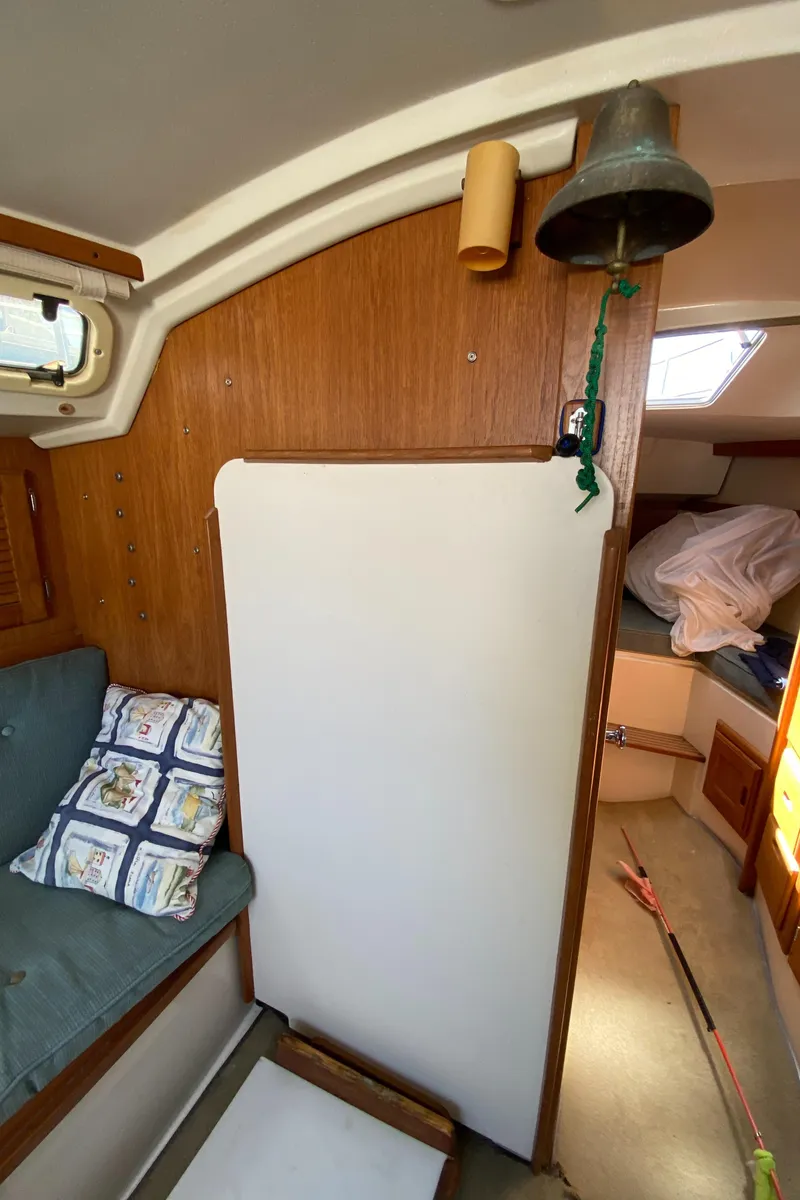 Slide: The Image of Interior of a 1992 Catalina 30 MkII sailboat with cozy seating and nautical decor. - 23