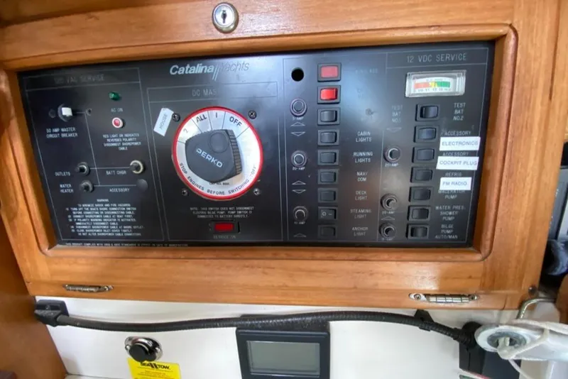 Slide: The Image of Control panel of a 1992 Catalina 30 MkII sailboat with various switches and gauges. - 28