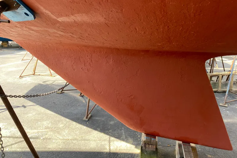 Slide: The Image of Red hull of a 1992 Catalina 30 MkII sailboat on a stand. - 3