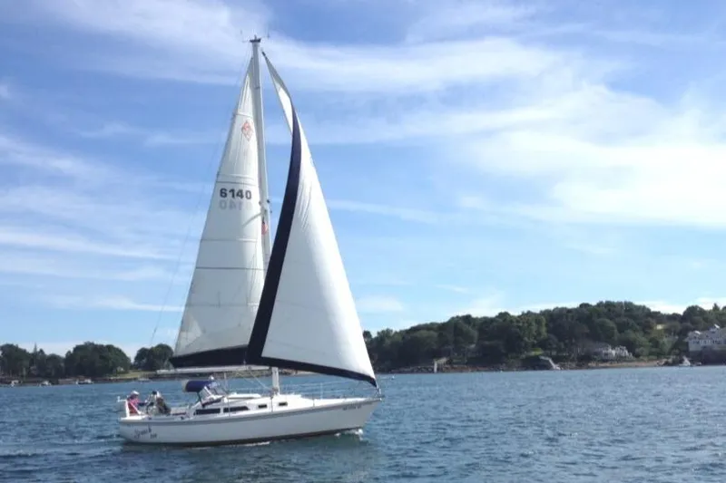 Slide: The Image of Sailing on a 1992 Catalina 30 MkII yacht in a scenic coastal area. - 31