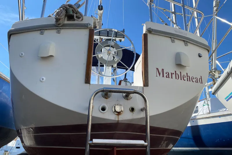 Slide: The Image of Catalina 30 MkII sailboat, 1992 model, named "Marblehead," docked with visible stern and ladder. - 4