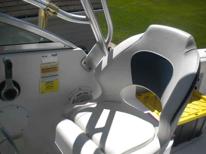 Slide: The Image of 2003 Pro-Line 23 Walk boat interior with white and black seating. - 12