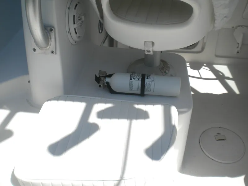 Slide: The Image of 2003 Pro-Line 23 Walk boat interior with fire extinguisher and seating. - 15