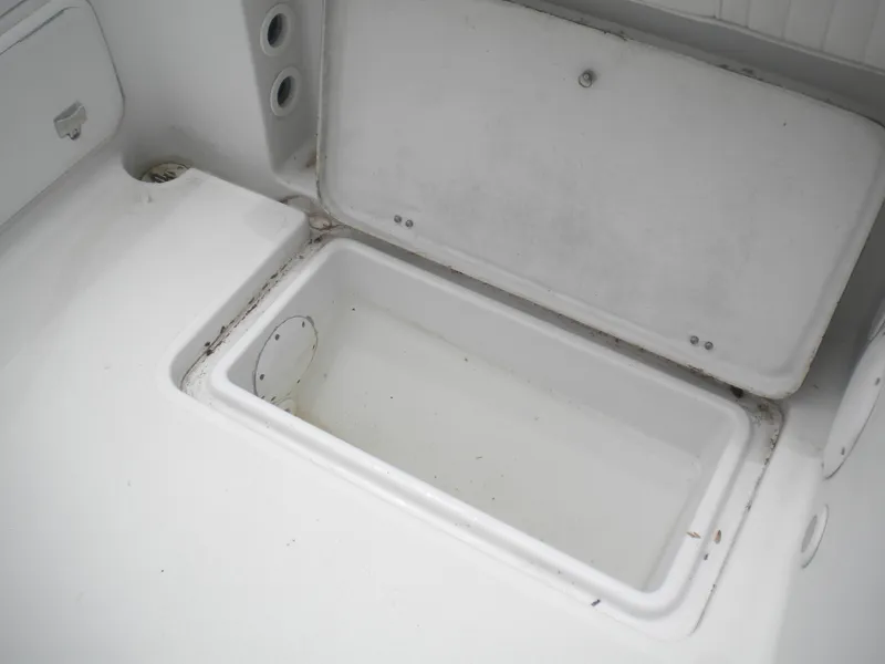 Slide: The Image of Open storage compartment on a 2003 Pro-Line 23 Walk boat. - 18