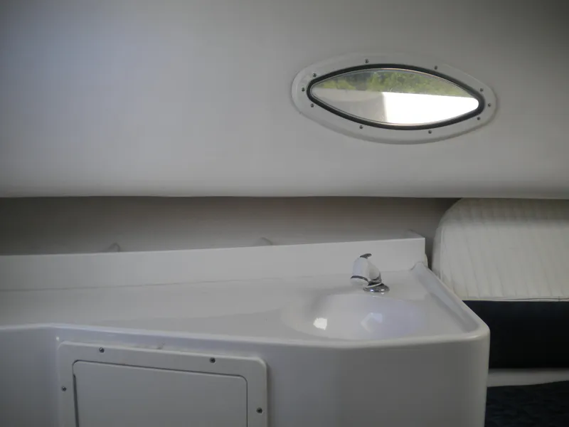 Slide: The Image of 2003 Pro-Line 23 Walk cabin interior with sink and oval window. - 23