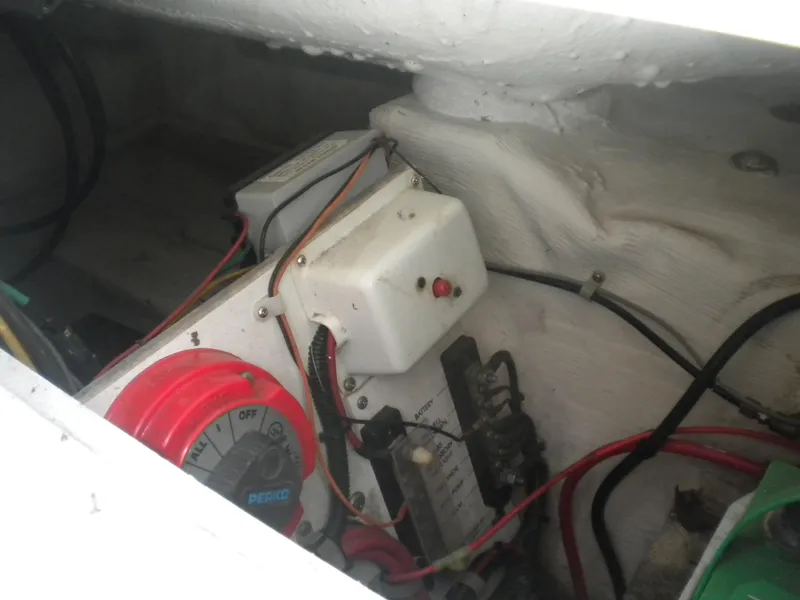 Slide: The Image of Electrical components inside a 2003 Pro-Line 23 Walk boat, featuring wiring and switches. - 24