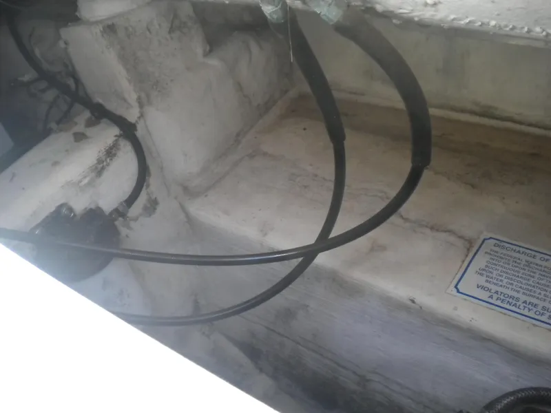 Slide: The Image of 2003 Pro-Line 23 Walk boat interior with visible wiring and maintenance label. - 25